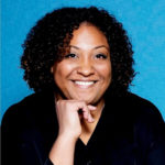 Audrey Marie-Nely, CITP headshot with blue background