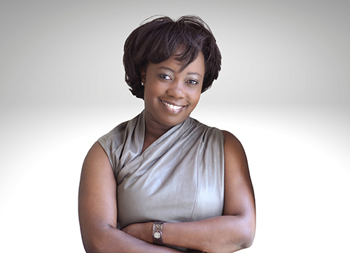 Erica Henry-Jackman portrait on grey background